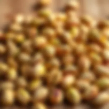 A collection of fresh pistachios with shells on a wooden surface