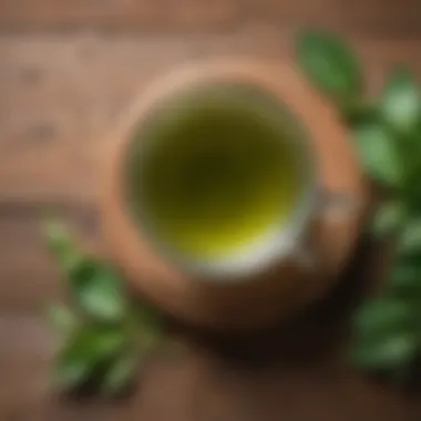 The Essence of Green Tea A serene cup of green tea sitting on a wooden table surrounded by fresh tea leaves.
